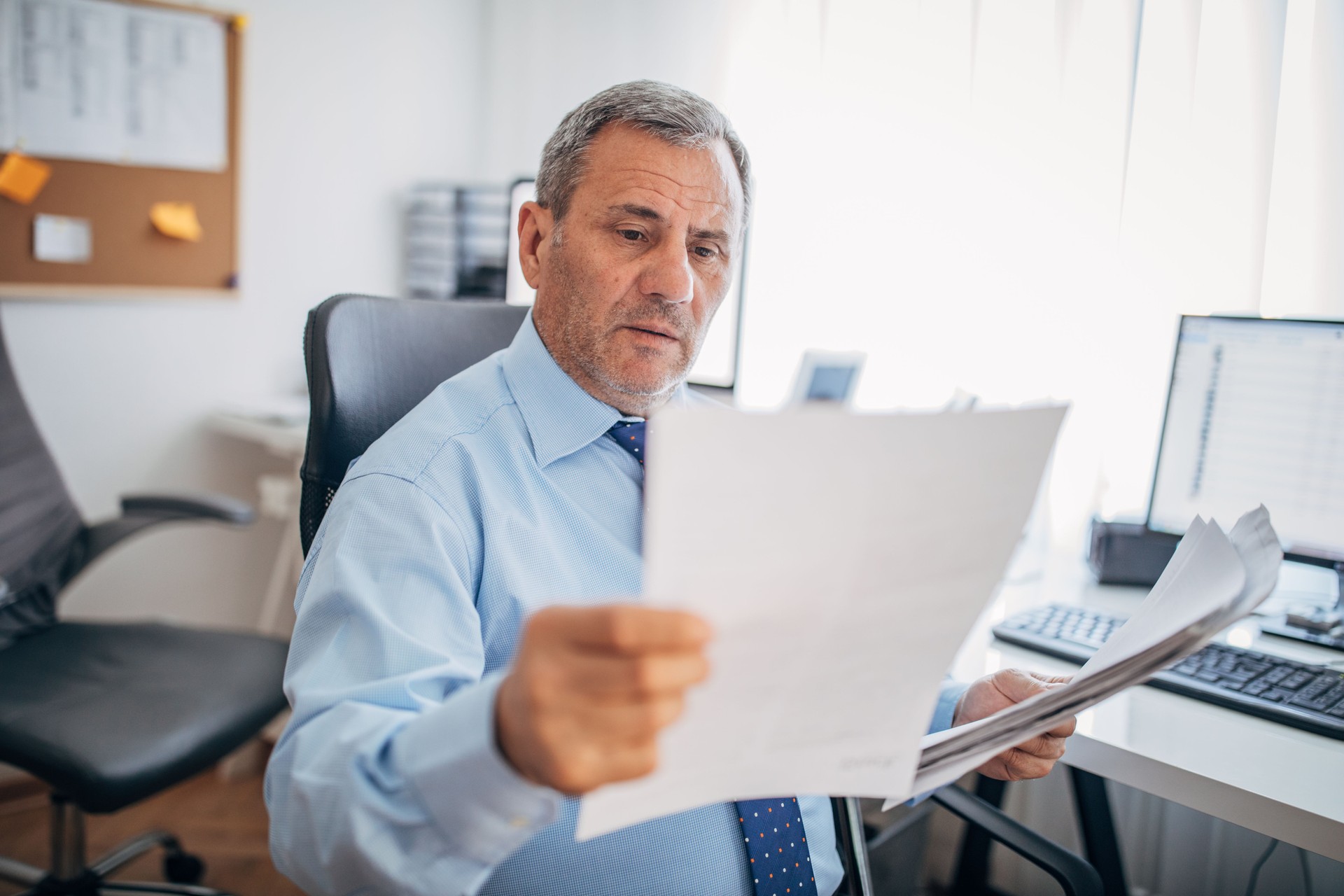 Senior businessman reading documents at the office